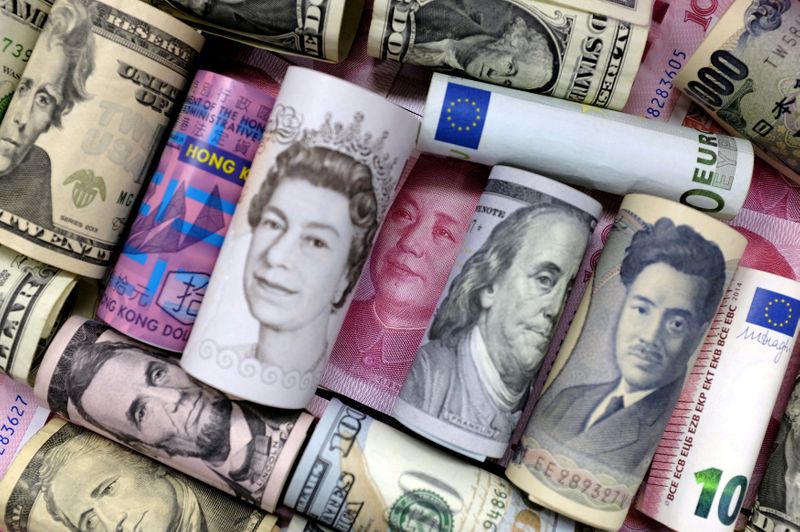 Pound Sterling notes and change are seen inside a cash resgister in a coffee shop in Manchester