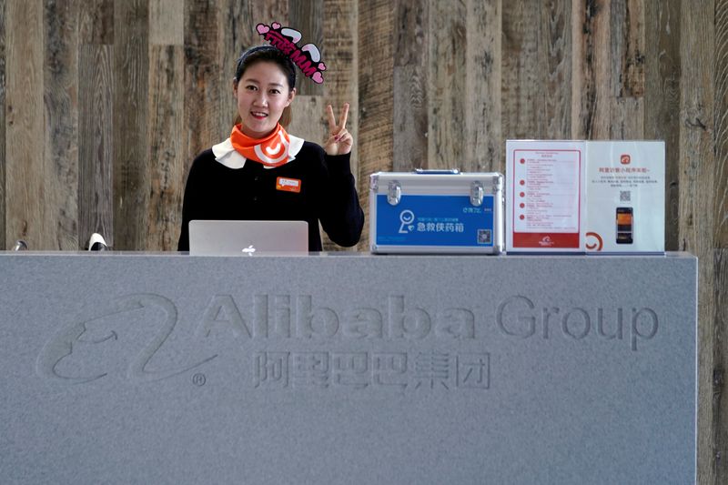 FILE PHOTO: An employee of Alibaba Group gestures during Alibaba Group's 11.11 Singles' Day