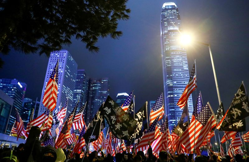 FILE PHOTO: Laser beams, coming from the residential buildings in Kowloon district, are seen as