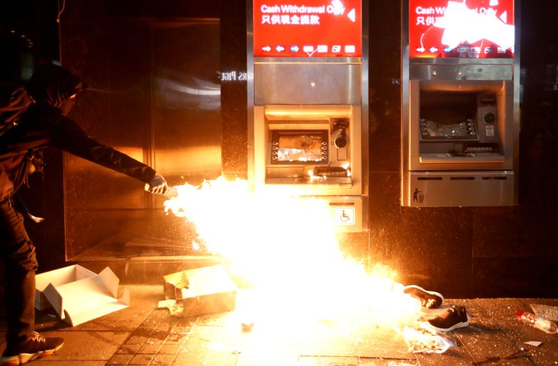 Vandalized automated teller machines (ATMs) are seen at a HSBC bank branch in Wan Chai during