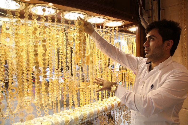 A goldsmith shop owner displays gold pieces at a gold market in Arbil, in Iraq's Kurdistan