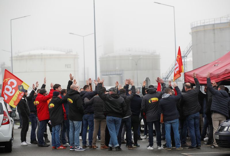 Workers of French oil giant Total gather in front of the oil refinery in Donges