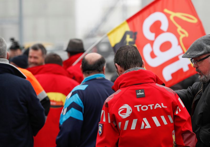 Workers of French oil giant Total gather in front of the oil refinery in Donges