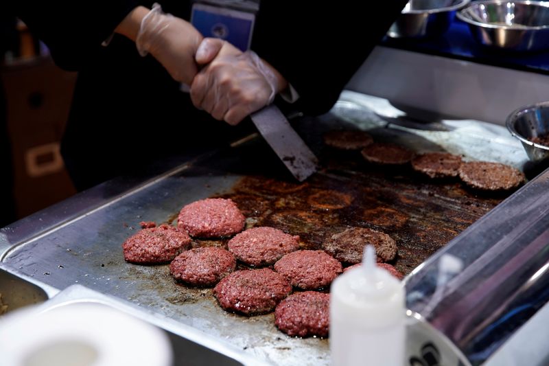 FILE PHOTO: A chef makes hamburgers out of plant-based meat by Impossible Foods at the second