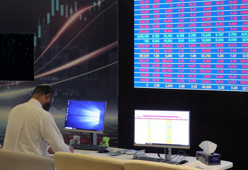 A trader uses a computer at the Doha Stock Exchange in Doha