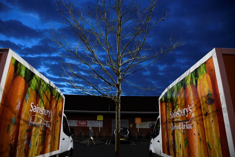 Signage for Sainsbury's is seen on delivery vans at a branch of the supermarket in London