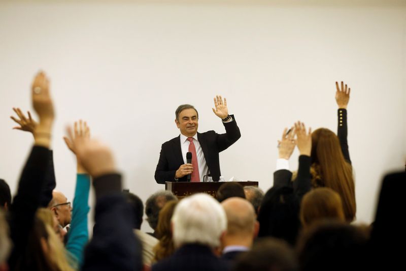 Former Nissan chairman Carlos Ghosn poses for a selfie picture during a news conference at the