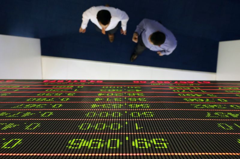 A trader uses a computer at the Doha Stock Exchange in Doha