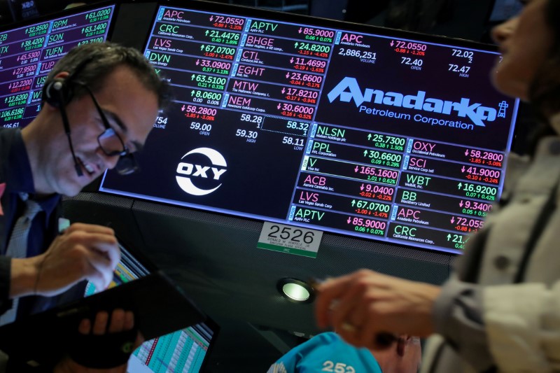 FILE PHOTO: Traders work on the floor by the post that trades Anadarko Petroleum and Occidental