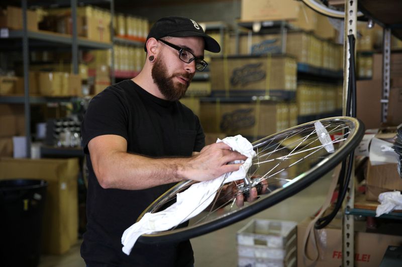 Gabe Ortiz services one of the company's products at State Bicycle in Tempe