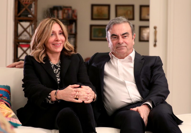 Former Nissan chairman Carlos Ghosn and his wife Carole Ghosn talk during an interview with