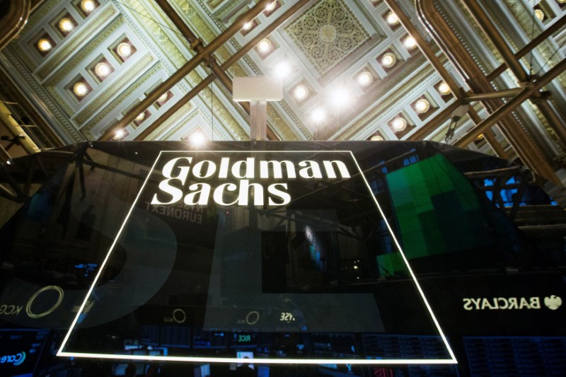 FILE PHOTO: Goldman Sachs sign is seen above floor of the New York Stock Exchange shortly after