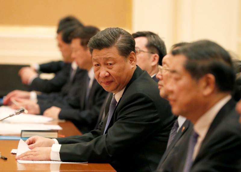 Myanmar State Counselor Aung San Suu Kyi shakes hands with Chinese President Xi Jinping at the