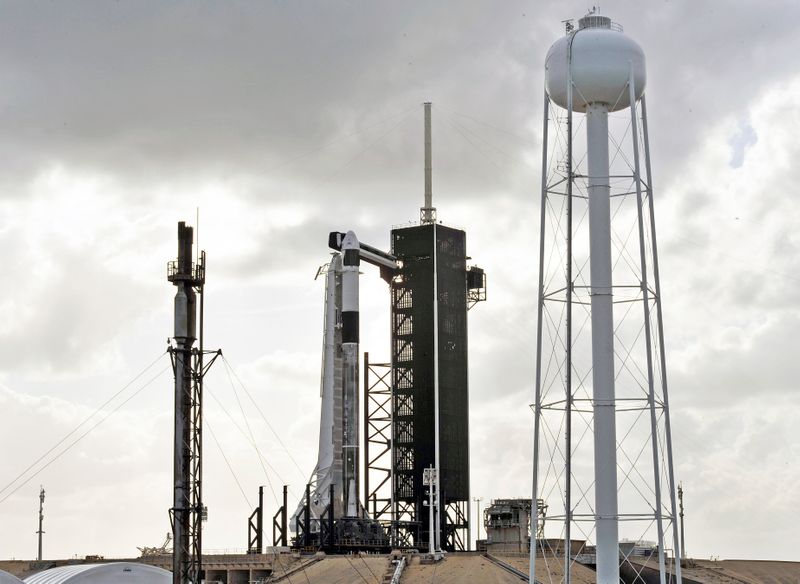 The SpaceX Crew Dragon sits atop a Falcon 9 booster rocket on Pad 39A at Kennedy Space Center