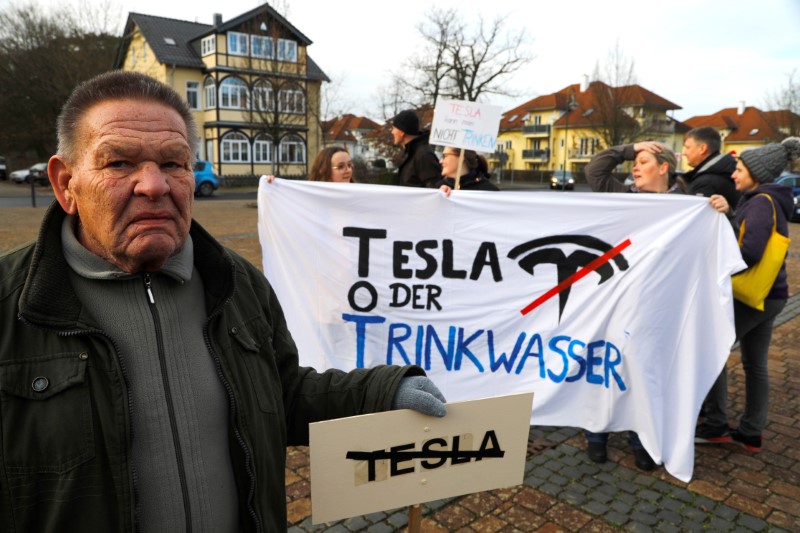 Demonstrators hold anti-Tesla posters during a protest against plans by U.S. electric vehicle