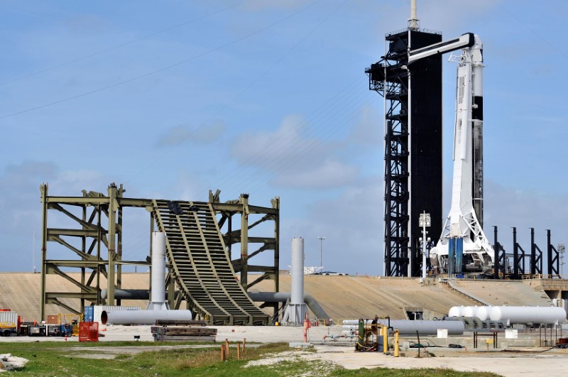 New construction surrounds the SpaceX Crew Dragon capsule atop a Falcon 9 booster rocket on