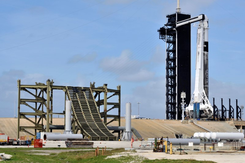 A SpaceX Falcon 9 rocket, carrying the Crew Dragon astronaut capsule, lifts off on an in-flight