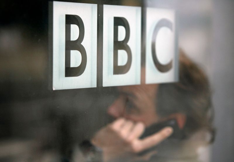 A man talks on a mobile phone inside the BBC headquarters in London