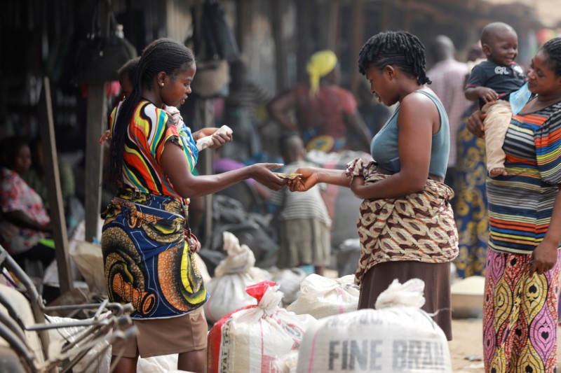 A woman food shopping checks out rice at Wurukum Rice Mill in Makurdi