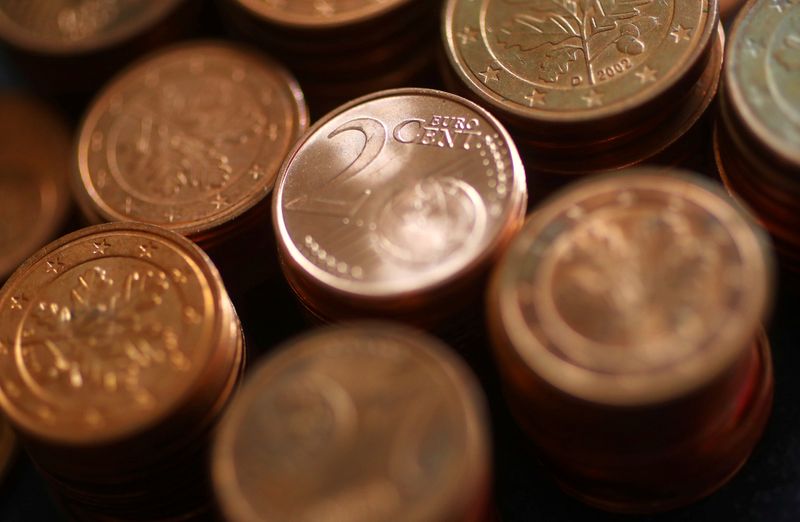 FILE PHOTO: An employee holds 2 cent euro coins at the 
