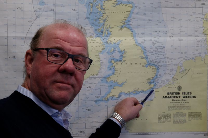 Bruno Margolle, a retired fisherman, shows the median line which separates English and French