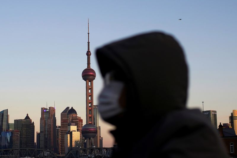 A driver wears a mask as he drives in Shanghai