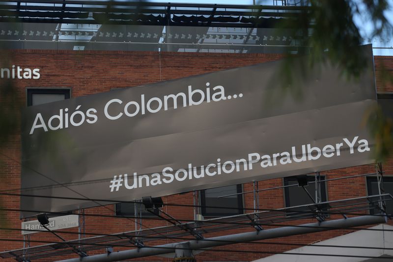 Uber driver Londono drives her car down a central street in Bogota