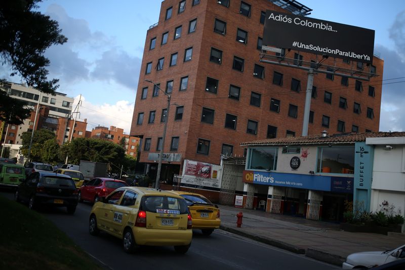 Uber driver Londono drives her car down a central street in Bogota
