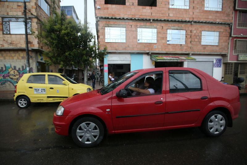 Uber driver Londono drives her car down a central street in Bogota