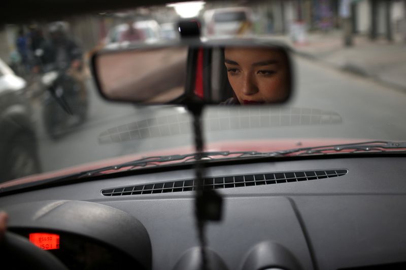 Passengers wait for a Transmilenio system bus during rush hour in Bogota