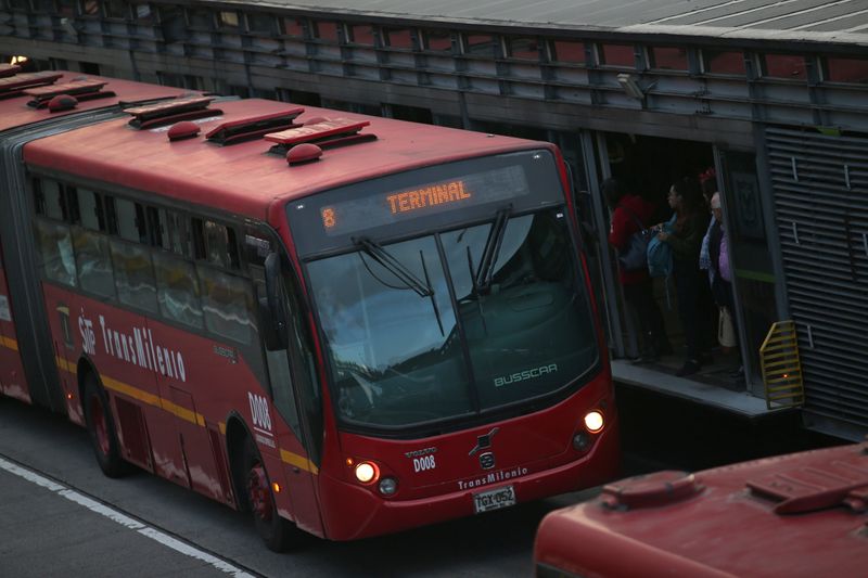 Passengers wait for a Transmilenio system bus during rush hour in Bogota