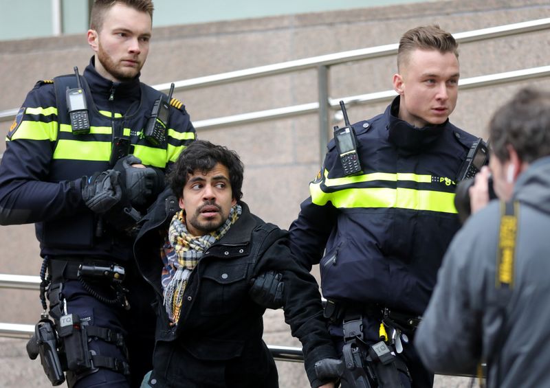 Activists block the entrance of the Shell headquarters in The Hague