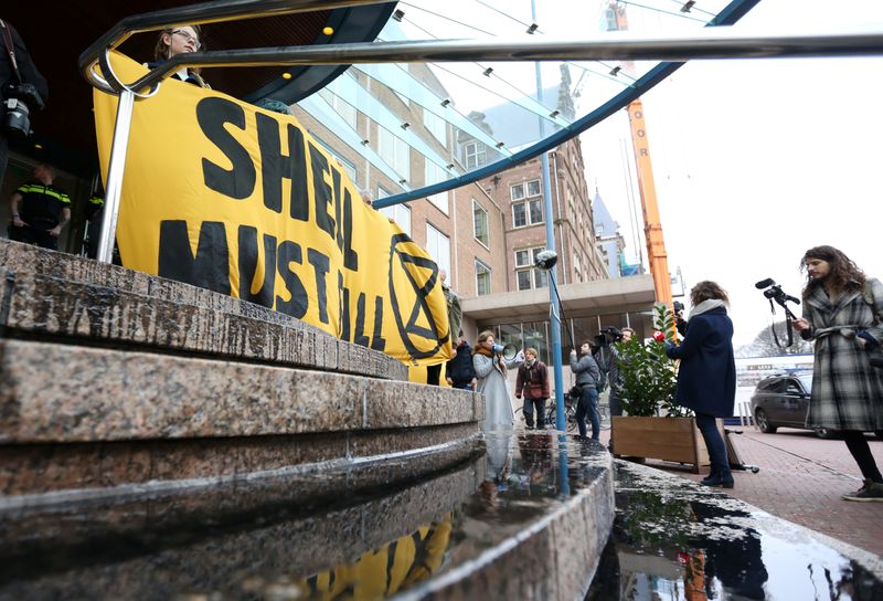 Activists block the entrance of the Shell headquarters in The Hague
