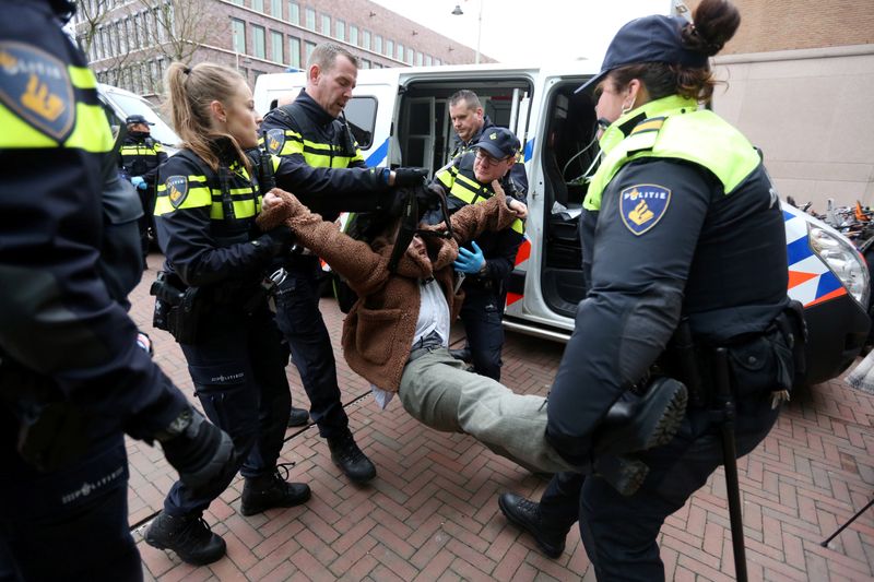 Activists block the entrance of the Shell headquarters in The Hague