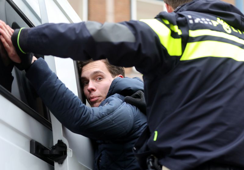 Activists block the entrance of the Shell headquarters in The Hague