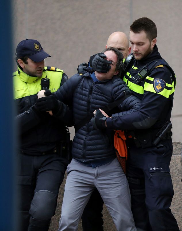 Activists block the entrance of the Shell headquarters in The Hague