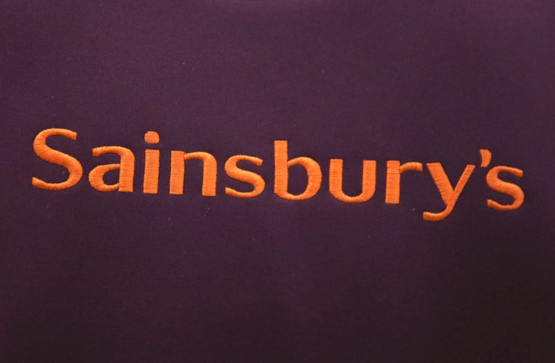FILE PHOTO: A worker's uniform displays company branding at a Sainsbury's store in London