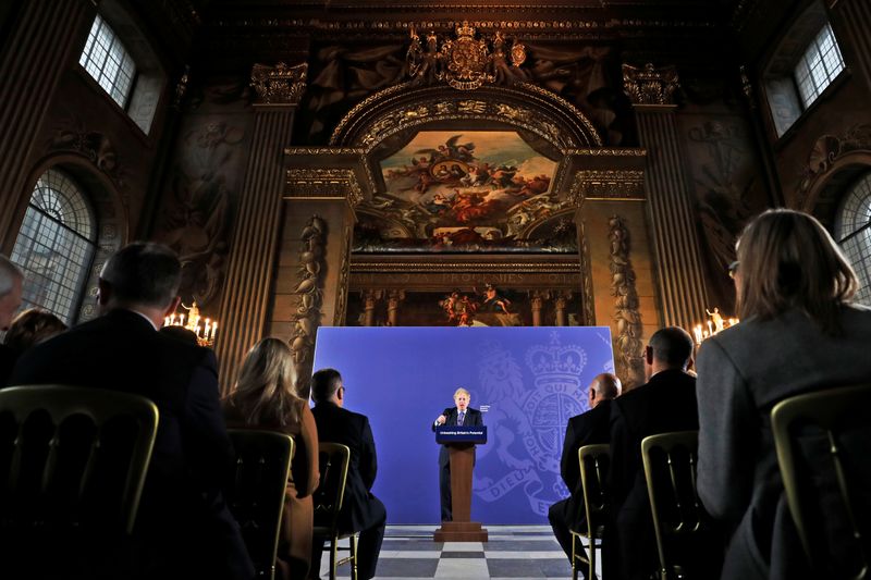 British Prime Minister Boris Johnson sits with David Attenborough during a conference about