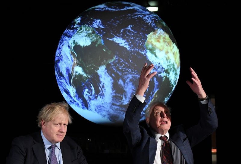 British Prime Minister Boris Johnson sits with David Attenborough during a conference about