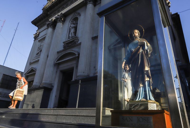 A woman walks down the stairs of Pope Francis' old church the Basilica San Jose de Flores, in