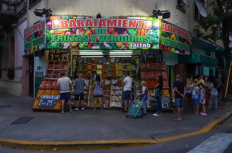 People buy fresh products at a store in the district of Flores where Pope Francis grew up, in
