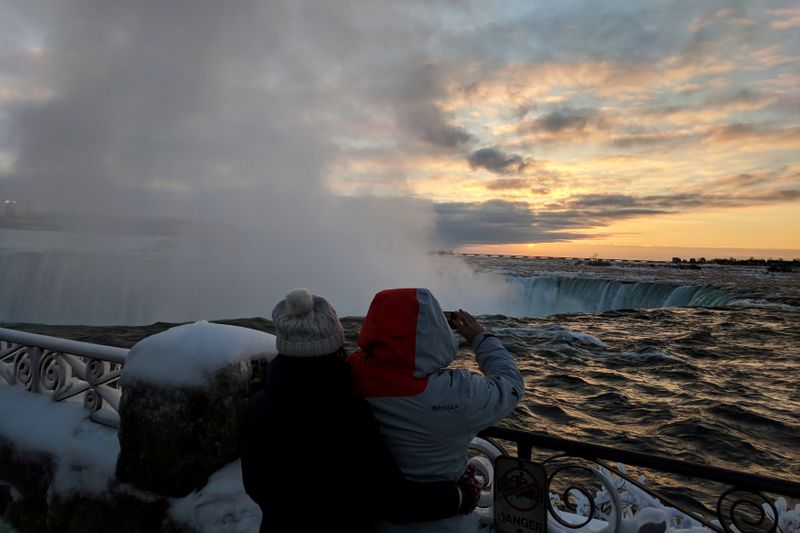 FILE PHOTO: Visitors take pictures near the brink of the ice covered Horseshoe Falls in Niagara