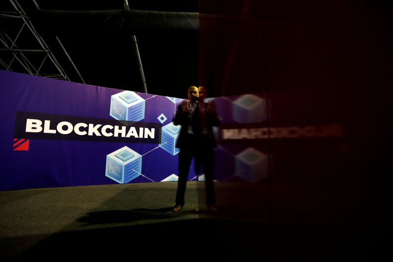 FILE PHOTO: A delegate talks on his phone at the Delta Summit, Malta's official Blockchain and
