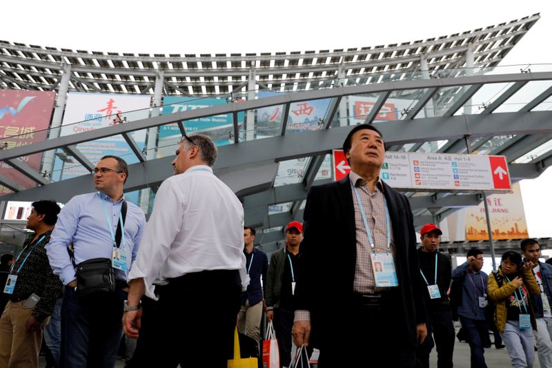 FILE PHOTO: Visitors attend the China Import and Export Fair, also known as Canton Fair, in the