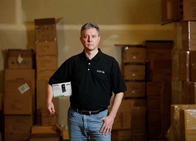 Bernie Thompson of Plugable Technologies holds a docking station that he sells on Amazon.com