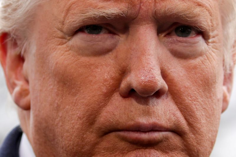 FILE PHOTO: U.S. President Trump speaks to reporters as he departs for travel to North Carolina