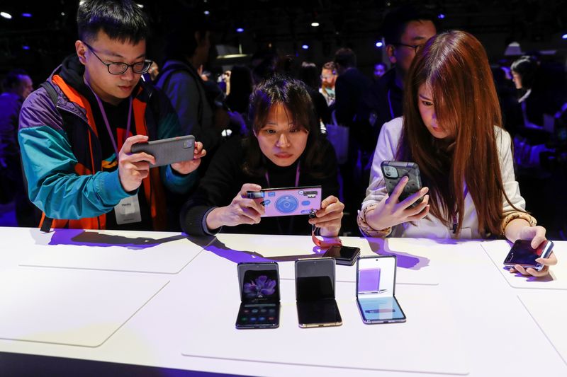 Attendees take photographs of the new Samsung Galaxy Z Flip foldable smartphone during Samsung