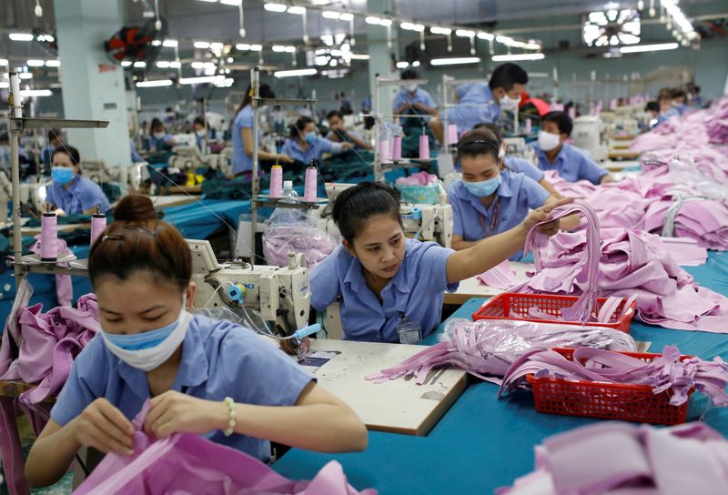 FILE PHOTO: Labourers work at a garment assembly line of Thanh Cong textile, garment,