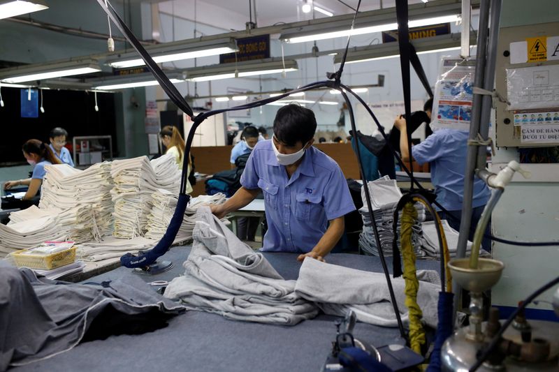 FILE PHOTO: A man works at a garment assembly line of Thanh Cong textile, garment, investment