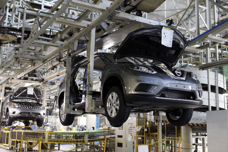 FILE PHOTO: Vehicles of Nissan Motor Co. move on the assembly line at the company's Kyushu